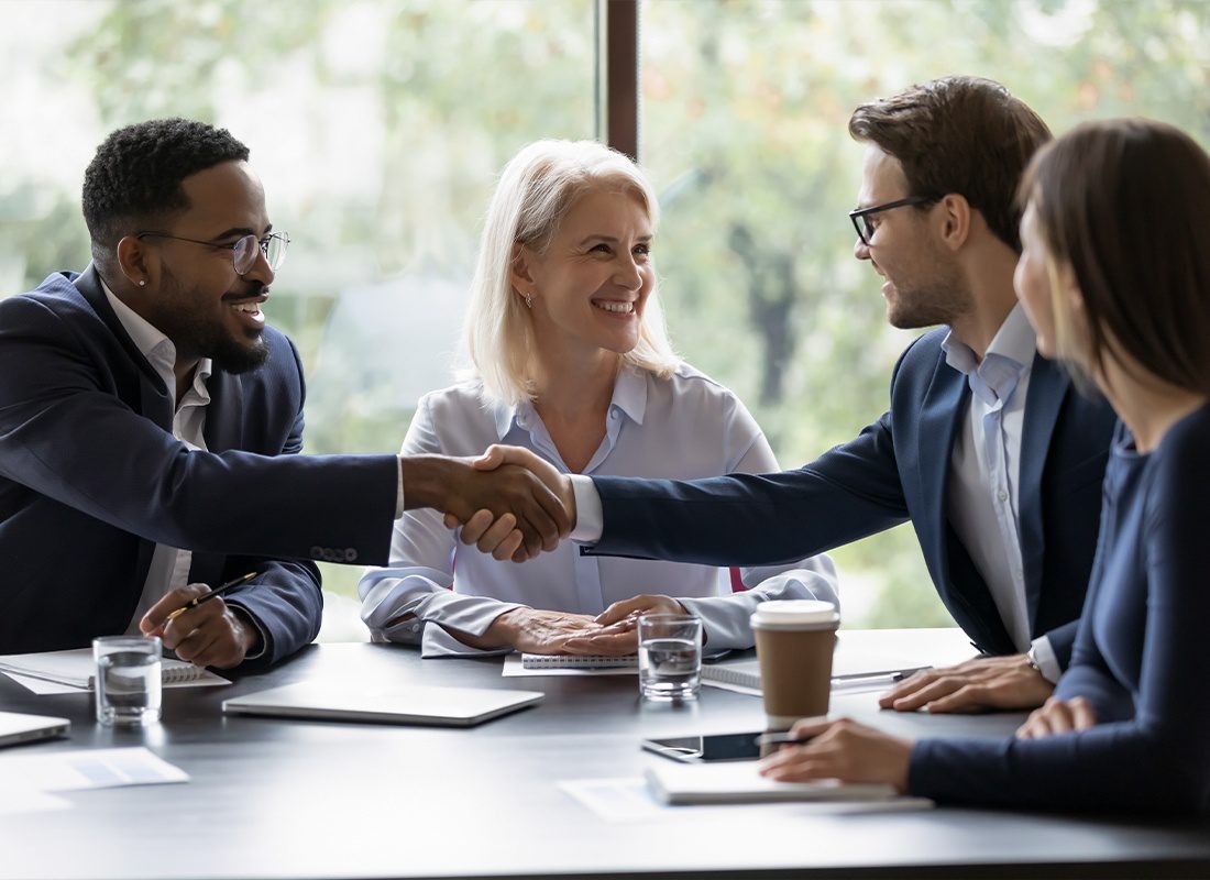 Our Business Partners - Smiling Diverse Businesspeople Shake Hands and Getting Acquainted